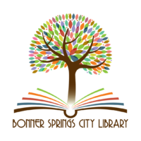Multicolored tree growing out of a book. Bonner Springs City Library is below it